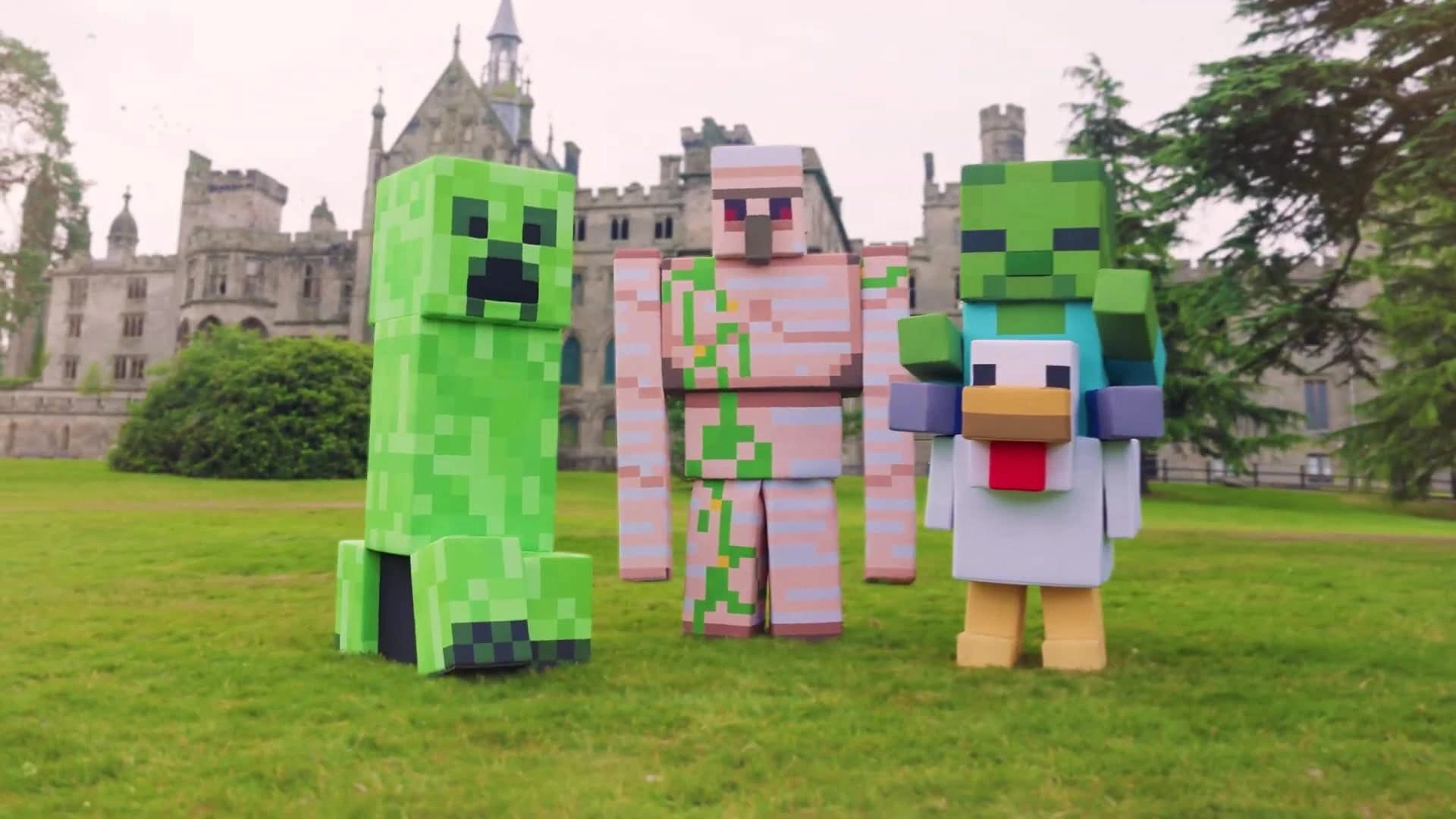 A Minecraft creeper, iron golem and baby zombie riding a chicken together on a castle lawn